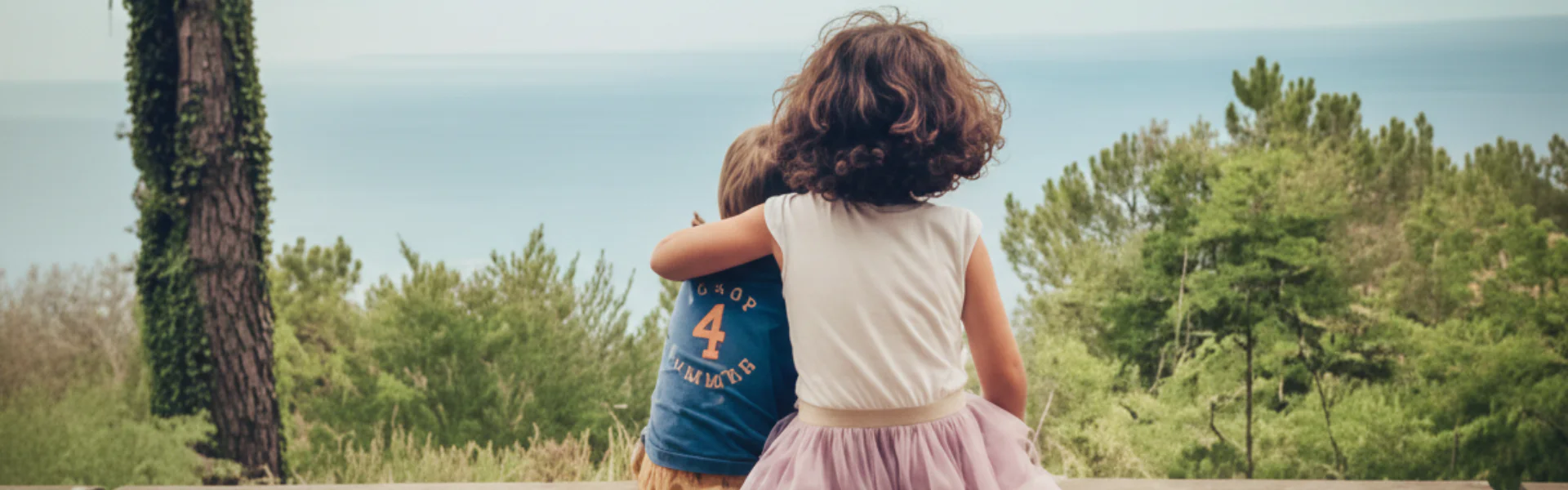 Dos niñas abrazadas frente al mar